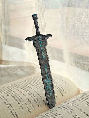 Runic blade sword bookmark with Norse runes on an open book.