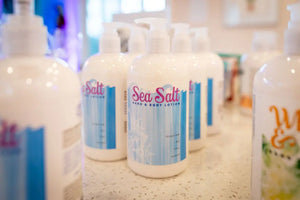 Bottles of Sea Salt hand and body lotion with blue and white labels.