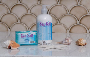 Sea Salt hand and body lotion, soap, and decorative seashells on a counter.