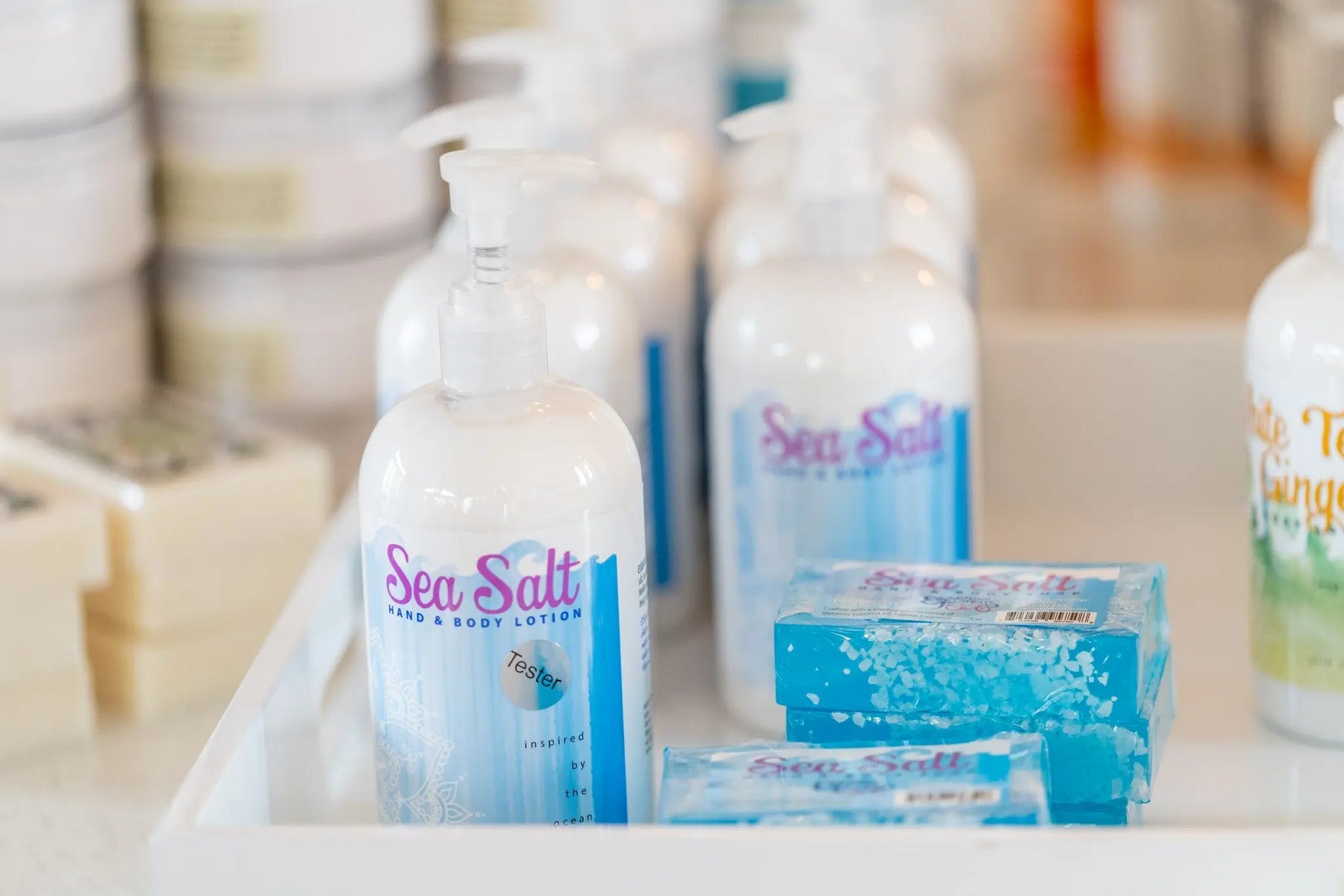 Sea Salt Hand & Body Lotion bottles and soap slices with blue and white packaging.