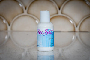 White bottle of Sea Salt Hand & Body Lotion with blue and white striped label.