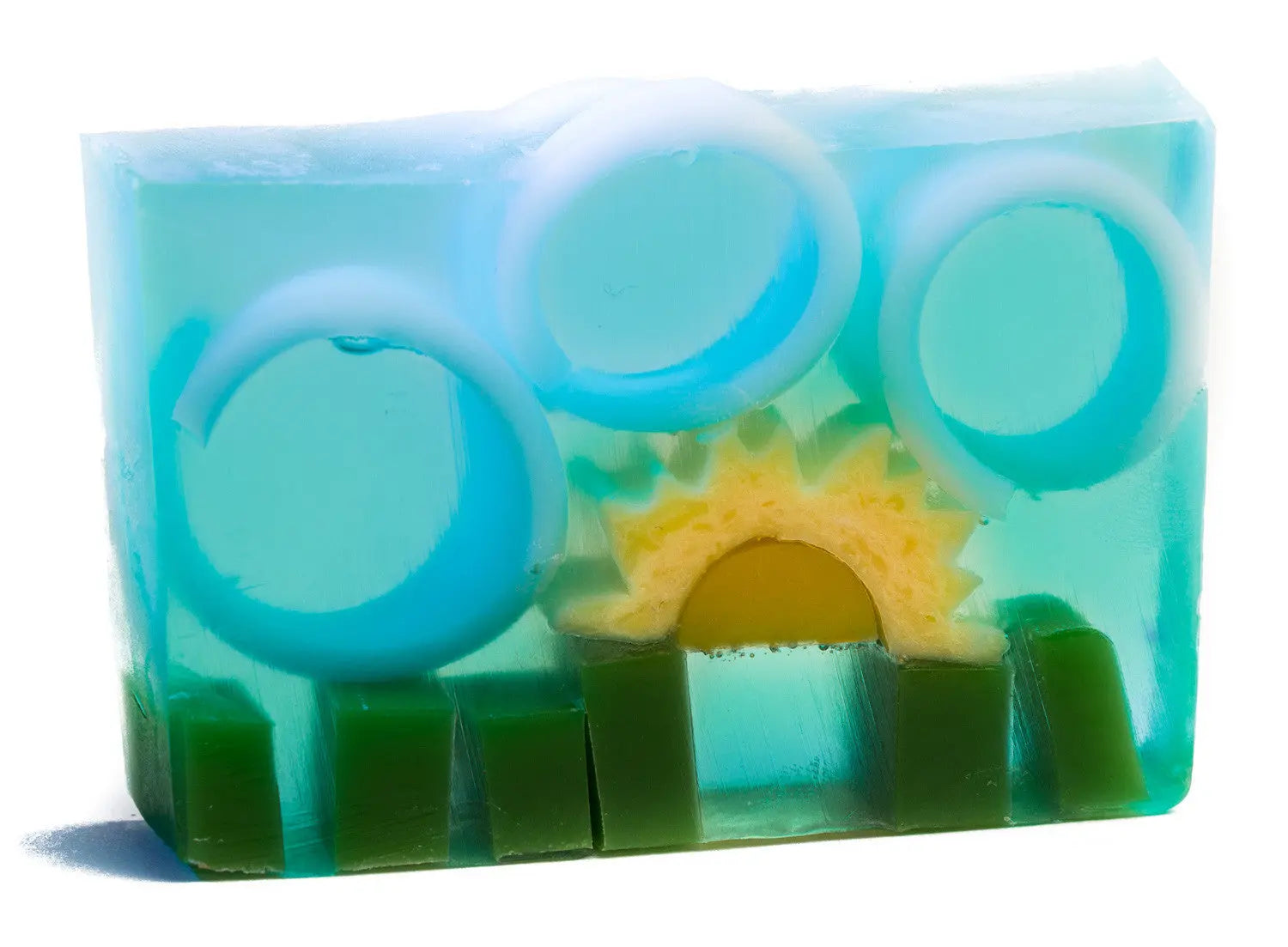 Clear blue soap slice with green grass, yellow sun, and white rings inside.