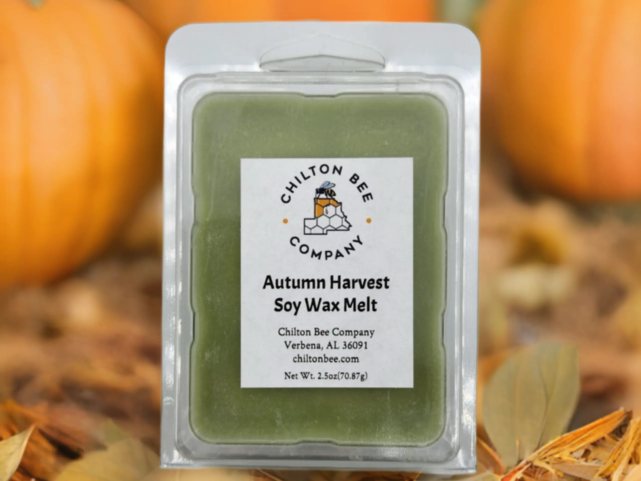 Autumn Harvest soy wax melt in clear packaging by Chilton Bee Company with pumpkin background