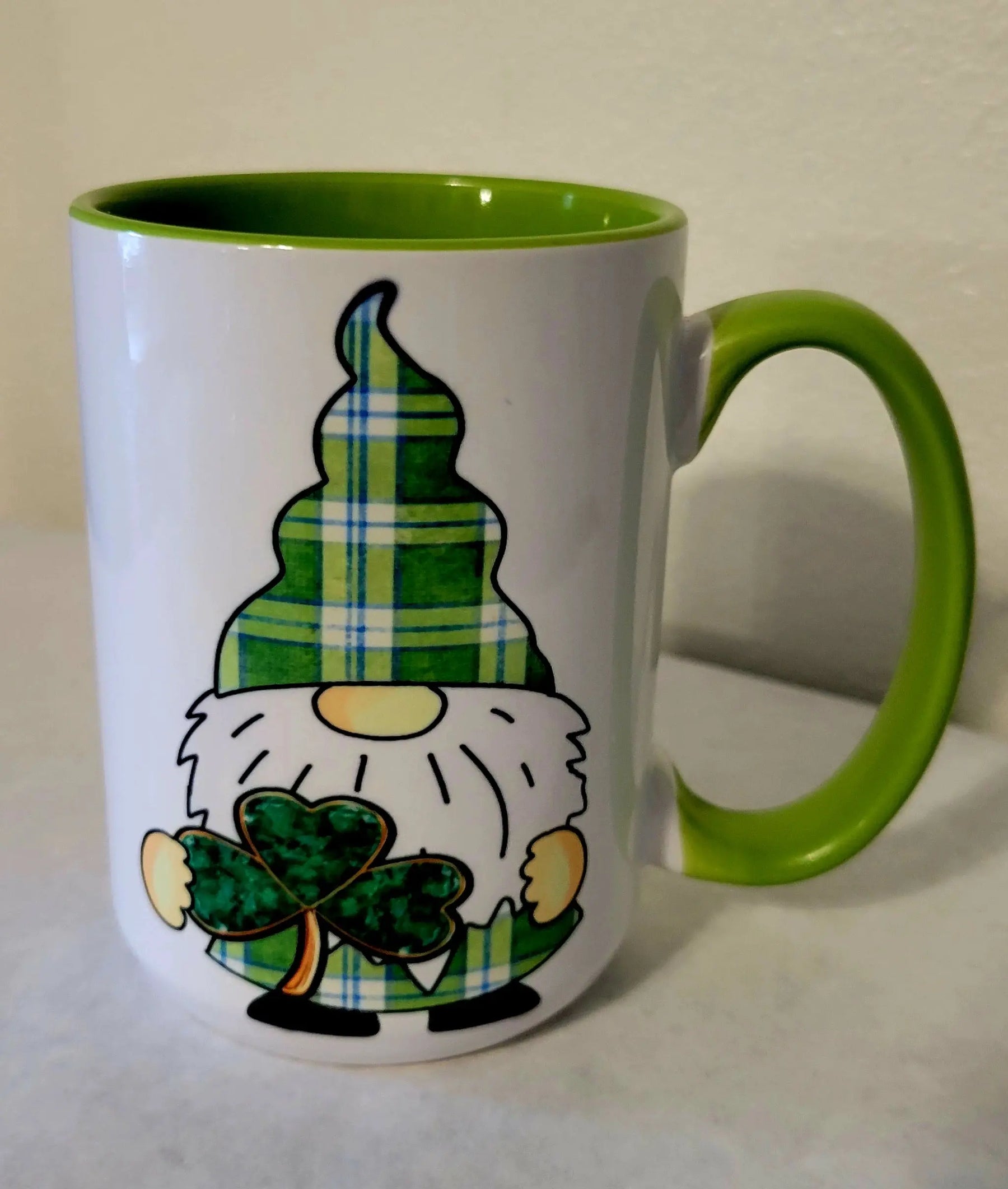 St. Patrick's Day gnome coffee mug with green handle and interior, featuring shamrock design.
