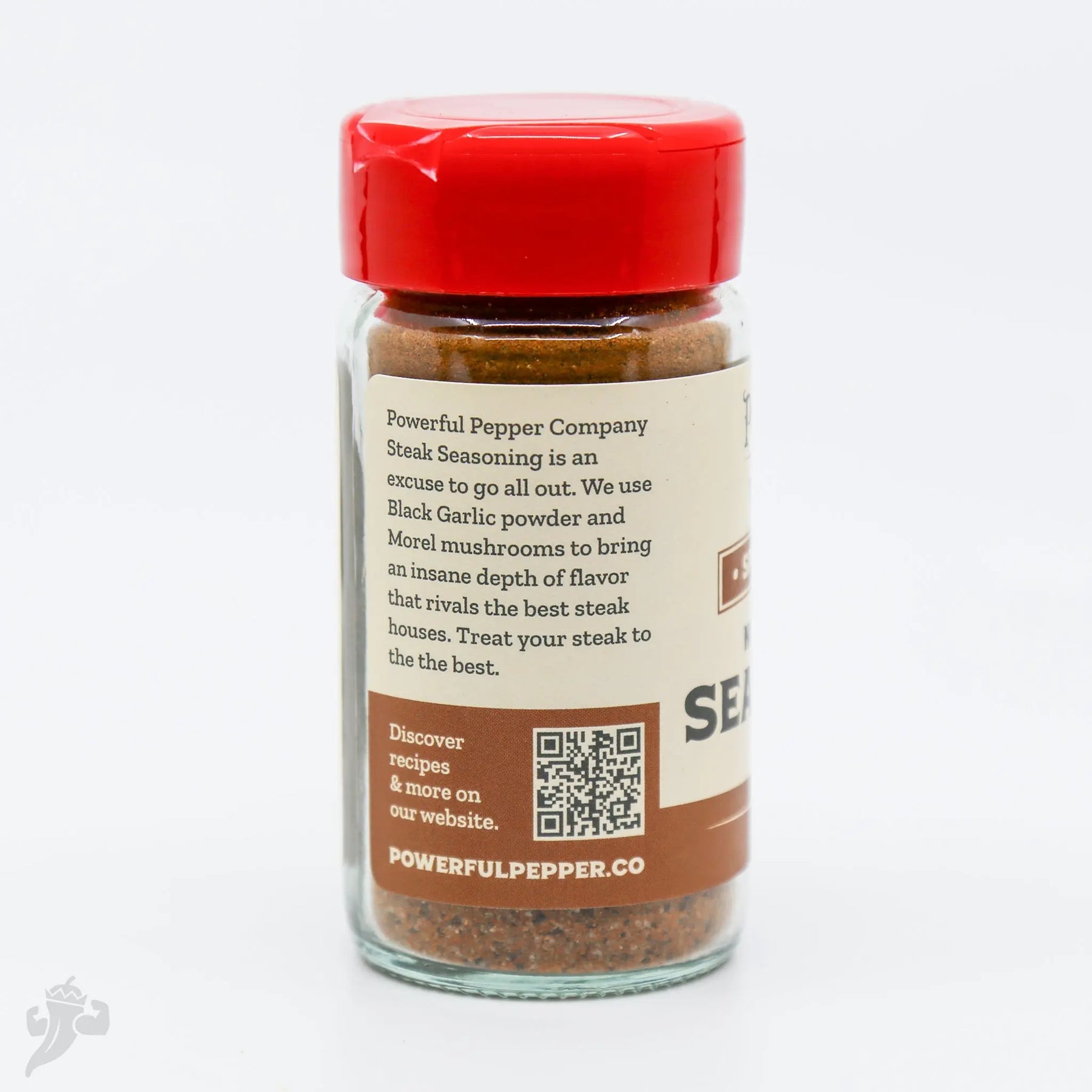 Powerful Pepper Company Steak Seasoning in a glass jar with a red lid.