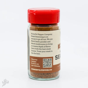 Powerful Pepper Company Steak Seasoning in a glass jar with a red lid.