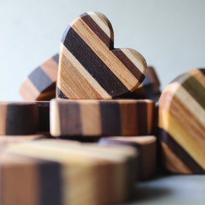 Striped wooden heart shapes made from assorted wood.