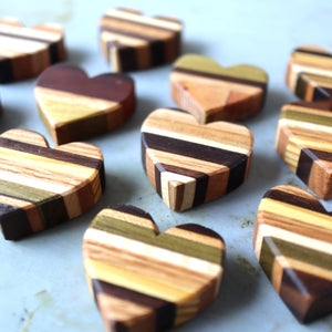 Striped wooden hearts in various multicolored wood grain patterns.