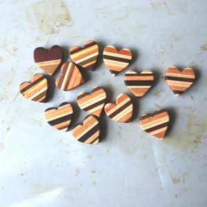 Collection of striped wooden heart shapes made from various reclaimed woods.