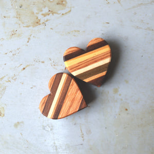 Two striped wooden hearts made of multi-colored wood pieces