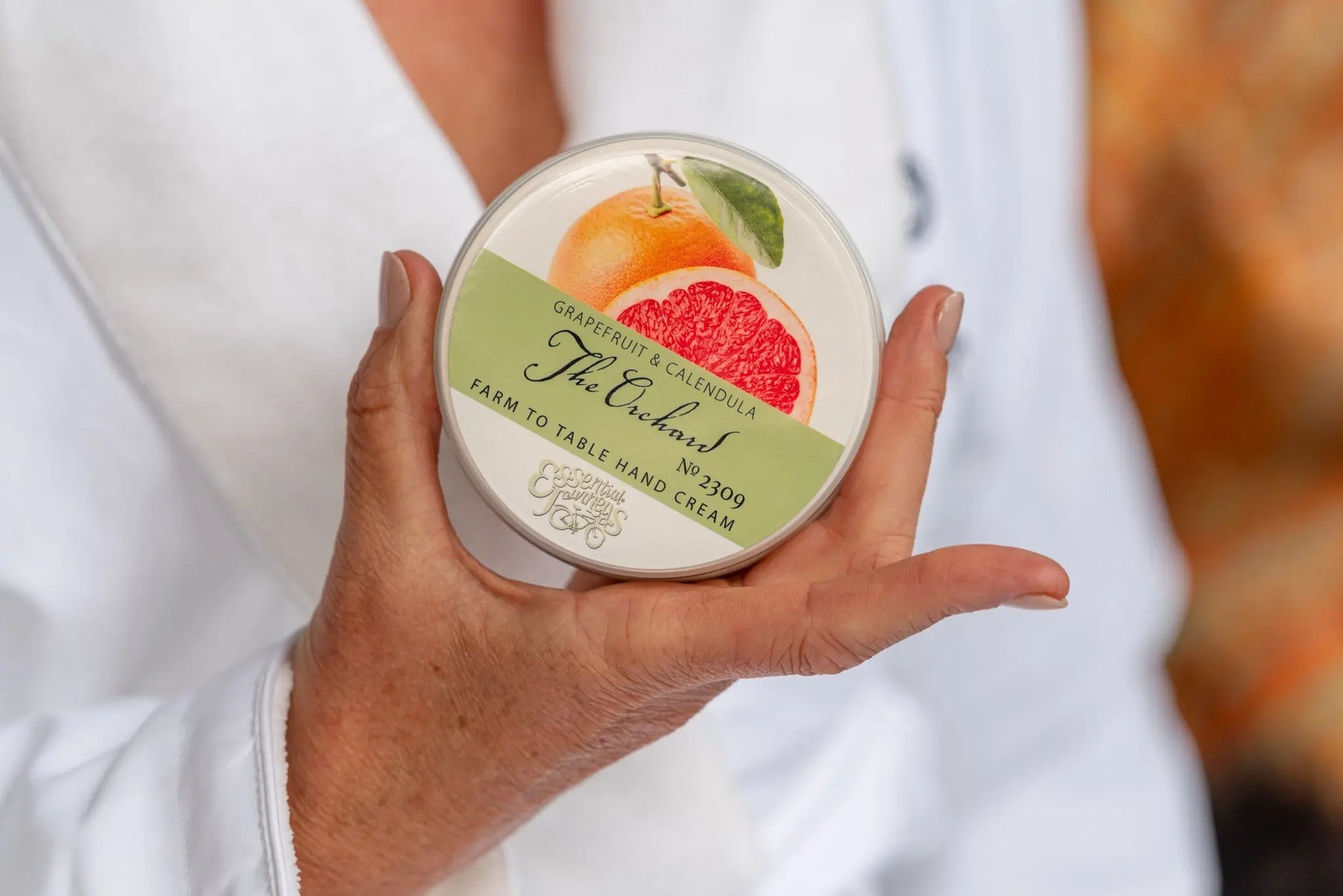 The Orchard Grapefruit & Calendula Farm to Table Hand Cream jar.