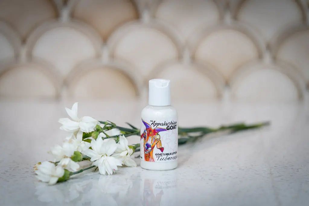 Small bottle of Appalachian Goat Tuberose Goat's Milk Lotion with white flowers