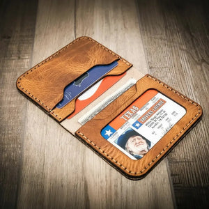 Brown leather bifold wallet holding Texas ID and multiple cards.