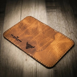 Brown distressed leather slim bifold wallet with embossed bull logo and stitching