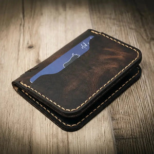 Black leather slim bifold wallet with card slots and visible stitching.