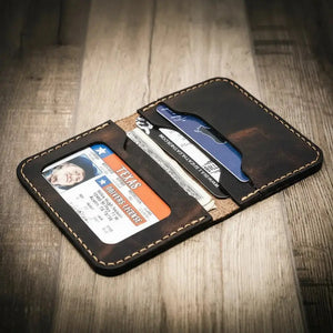 Dark brown leather bifold wallet with Texas ID, cards, and cash visible.