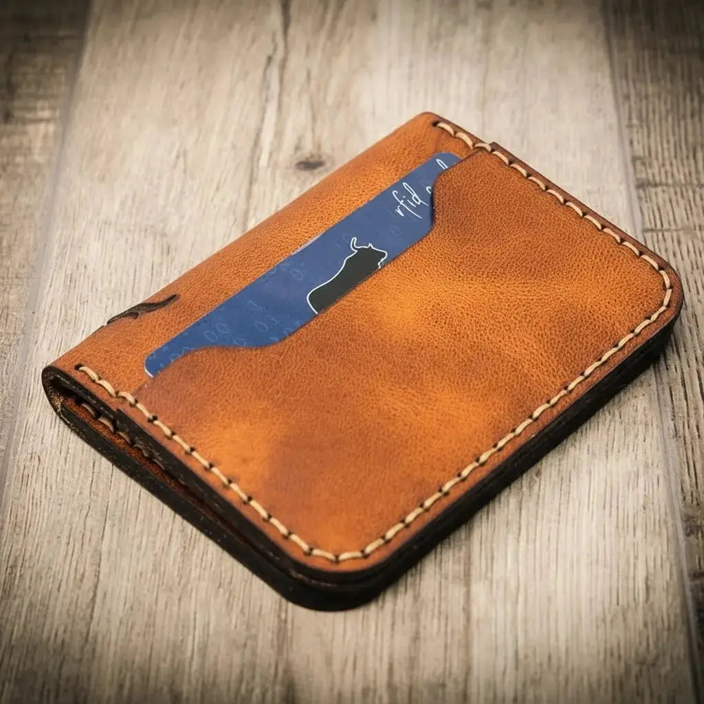 Brown leather slim bifold wallet with a blue card showing a bull silhouette and 'rfid'.