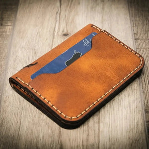 Brown leather slim bifold wallet with a blue card showing a bull silhouette and 'rfid'.