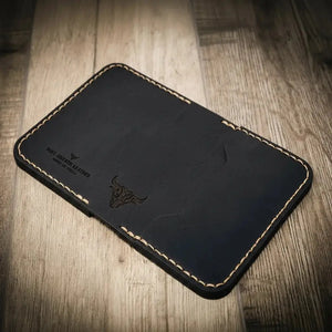 The Georgetown black leather bifold wallet with stitched edges and bull logo.