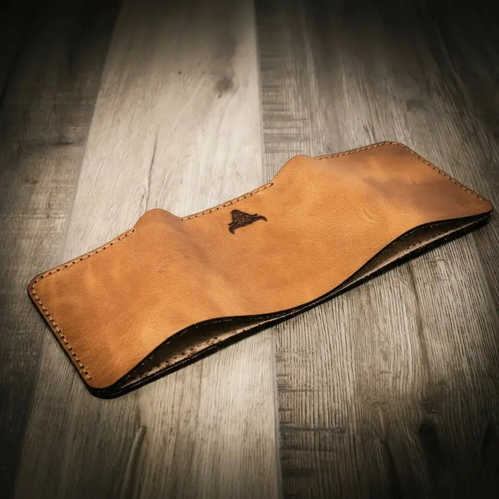 Full-grain leather texture and stitching on the Trinity Trifold Wallet