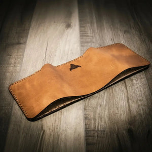 Full-grain leather texture and stitching on the Trinity Trifold Wallet