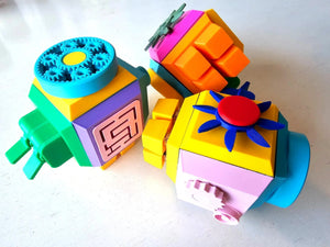 Colorful toy fidget cube with geometric shapes on a white background