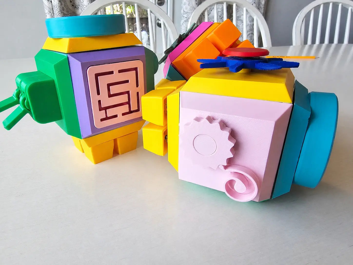 Colorful fidget cube for kids with geometric designs on a white surface