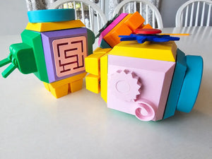 Colorful fidget cube for kids with geometric designs on a white surface
