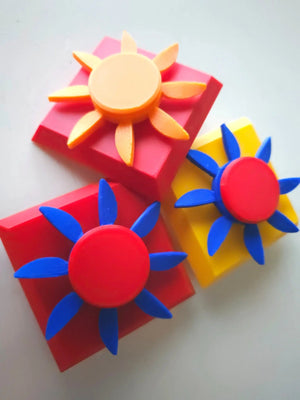 Colorful sun-shaped fidget spinners on a white background