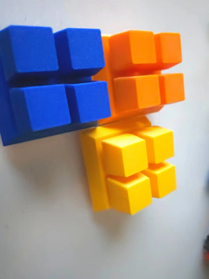 Colorful clicker blocks in blue, orange, and yellow on a white background