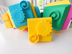 Colorful geometric fidget cube faces on a white surface