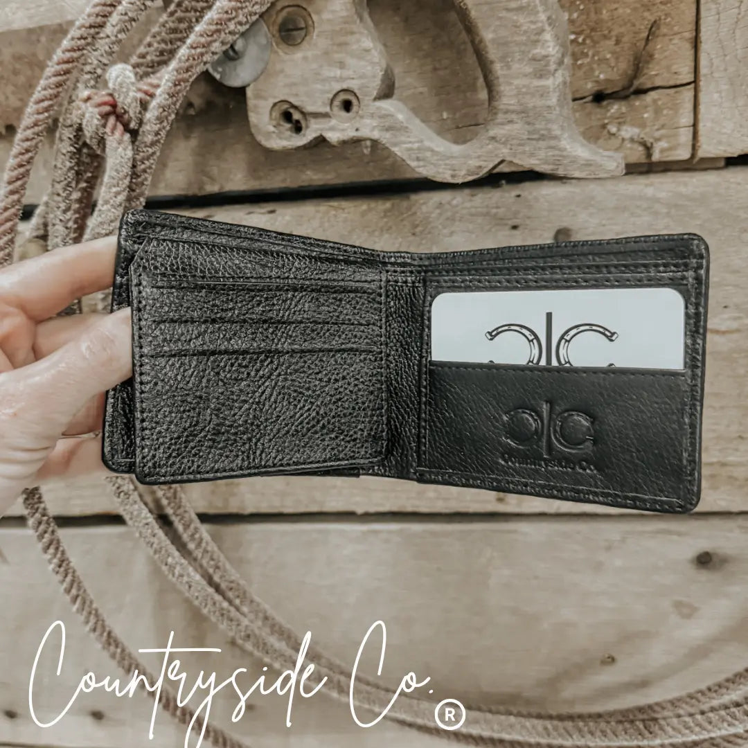 Black cowhide men's wallet by Countryside Co. folded open, showing interior card slots.