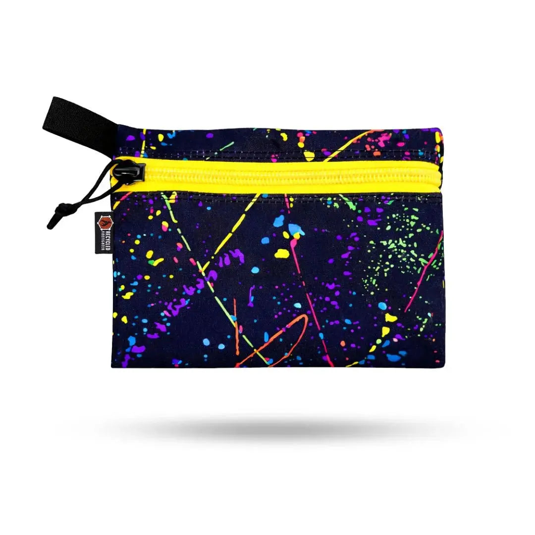 Dark pouch with yellow zipper and neon paint splatter design