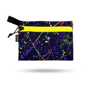 Dark pouch with yellow zipper and neon paint splatter design