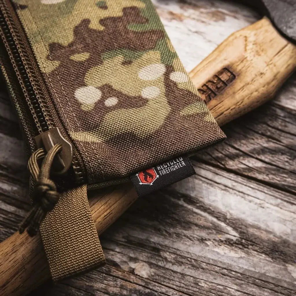Camouflage zippered pouch with Recycled Firefighter label and wooden handle.