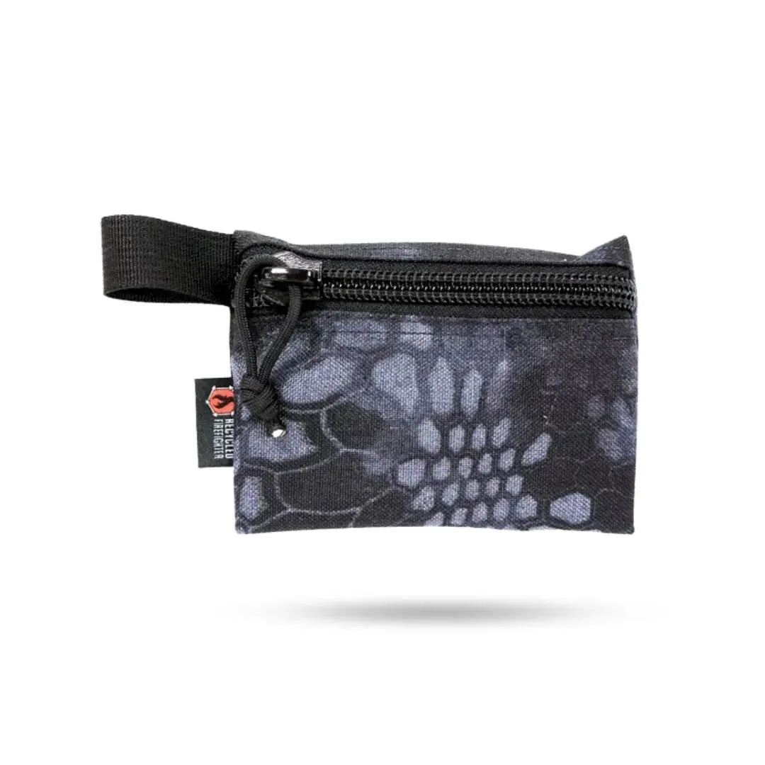 Small black camouflage zippered pouch with webbing loop and recycled firefighter tag.