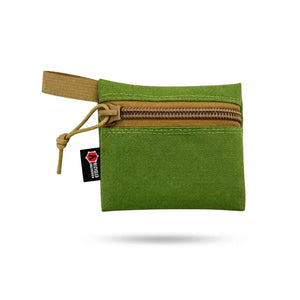 Small green zippered gear pouch with tan webbing tab.