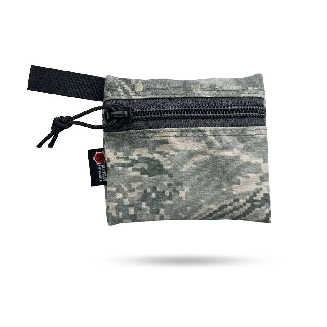 Small zippered pouch with digital camouflage pattern and black loop.