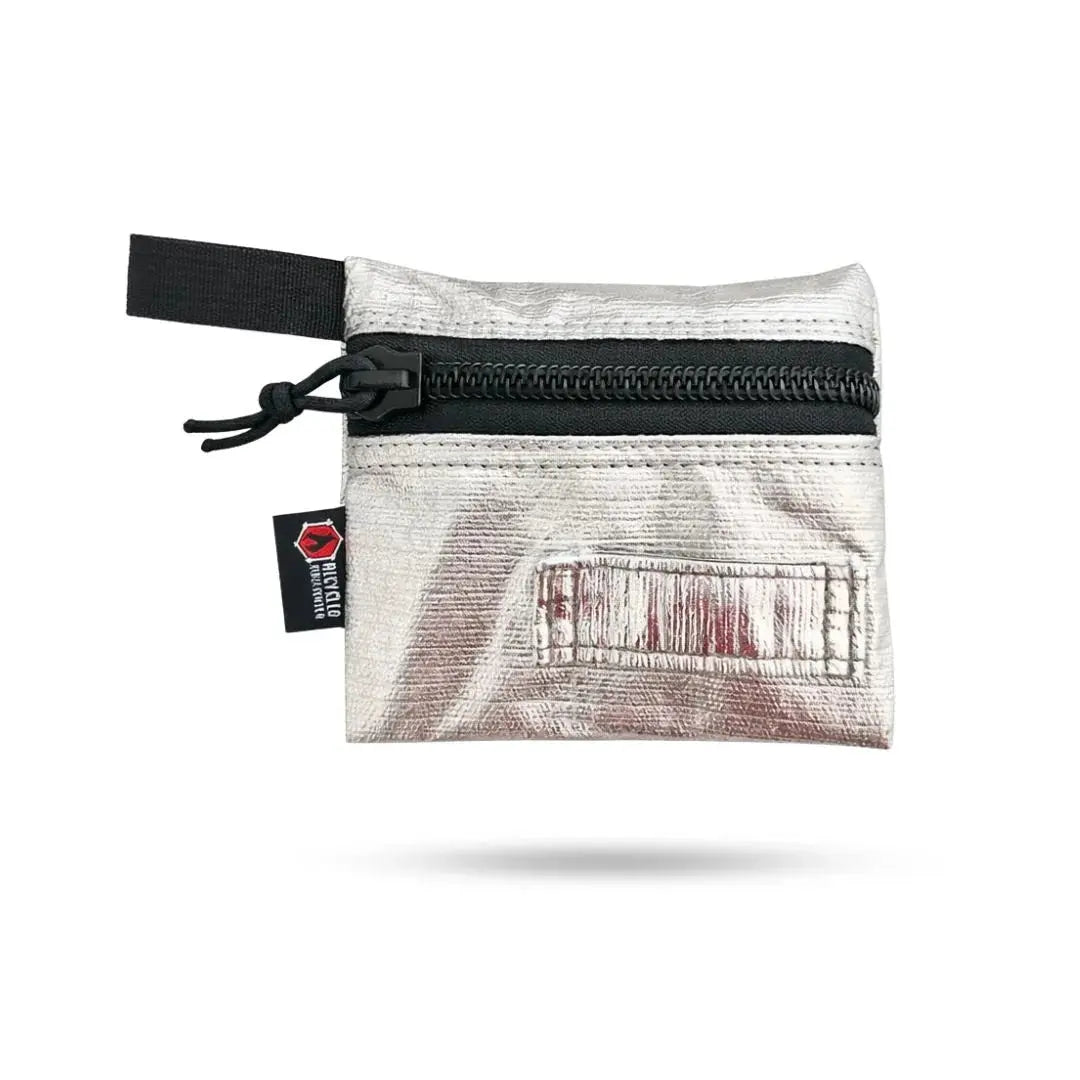 Small silver metallic zippered pouch with black loop and logo patch