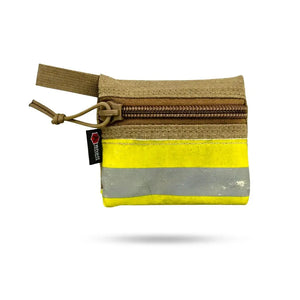 Small zippered pouch with yellow and reflective stripes made from firefighter gear fabric.