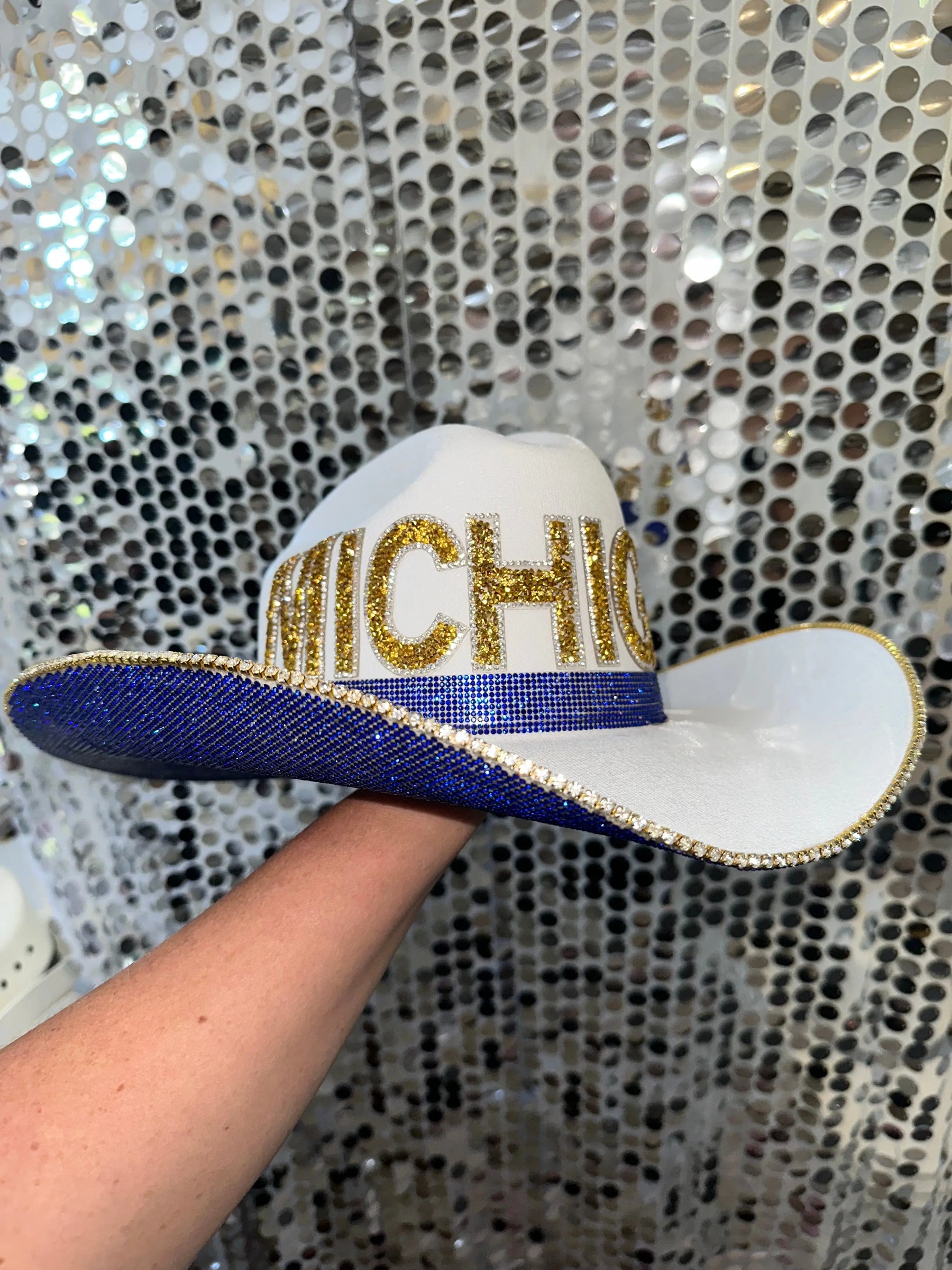 White straw cowboy hat with blue brim, gold "MICHIGAN" letters and rhinestones
