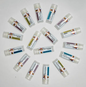 Assortment of Appalachian Goat vanilla swirl lip balm tubes arranged on a white background.