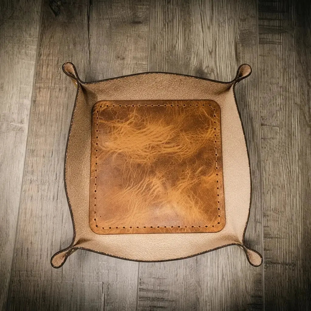 Brown leather valet tray with stitched edges for holding essentials
