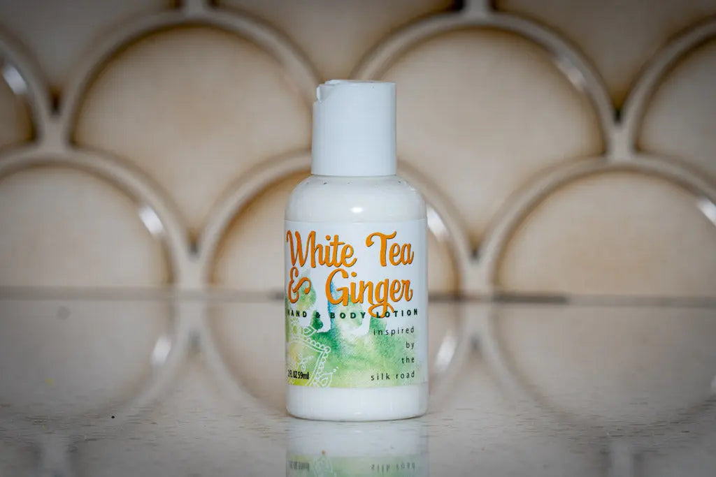 White Tea & Ginger hand and body lotion bottle, 2 oz travel size.
