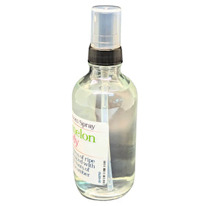 Clear glass bottle of Watermelon Candy room spray with black spray nozzle and product label.