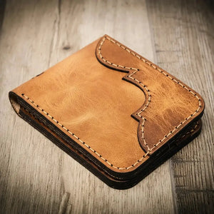 Brown leather bifold wallet with decorative stitching and Western flair.