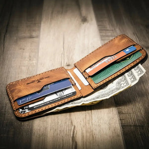 Brown leather bifold wallet holding credit cards and US dollar bills.
