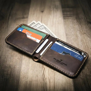 Brown leather bifold wallet with visible card slots and cash.