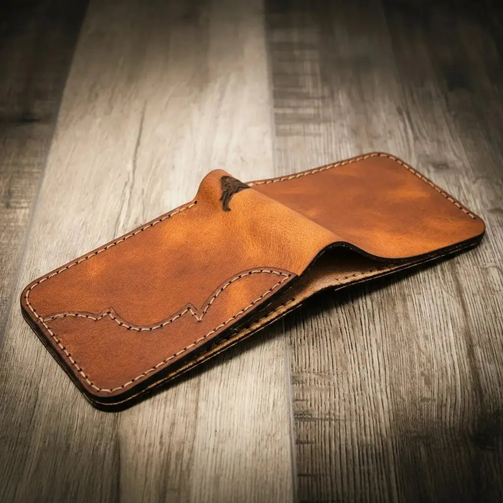 Brown leather bifold wallet open on a wooden surface.