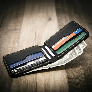 Black leather bifold wallet with cash and cards visible.